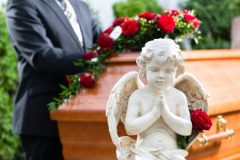 Casket with Angle Statue and Red Roses