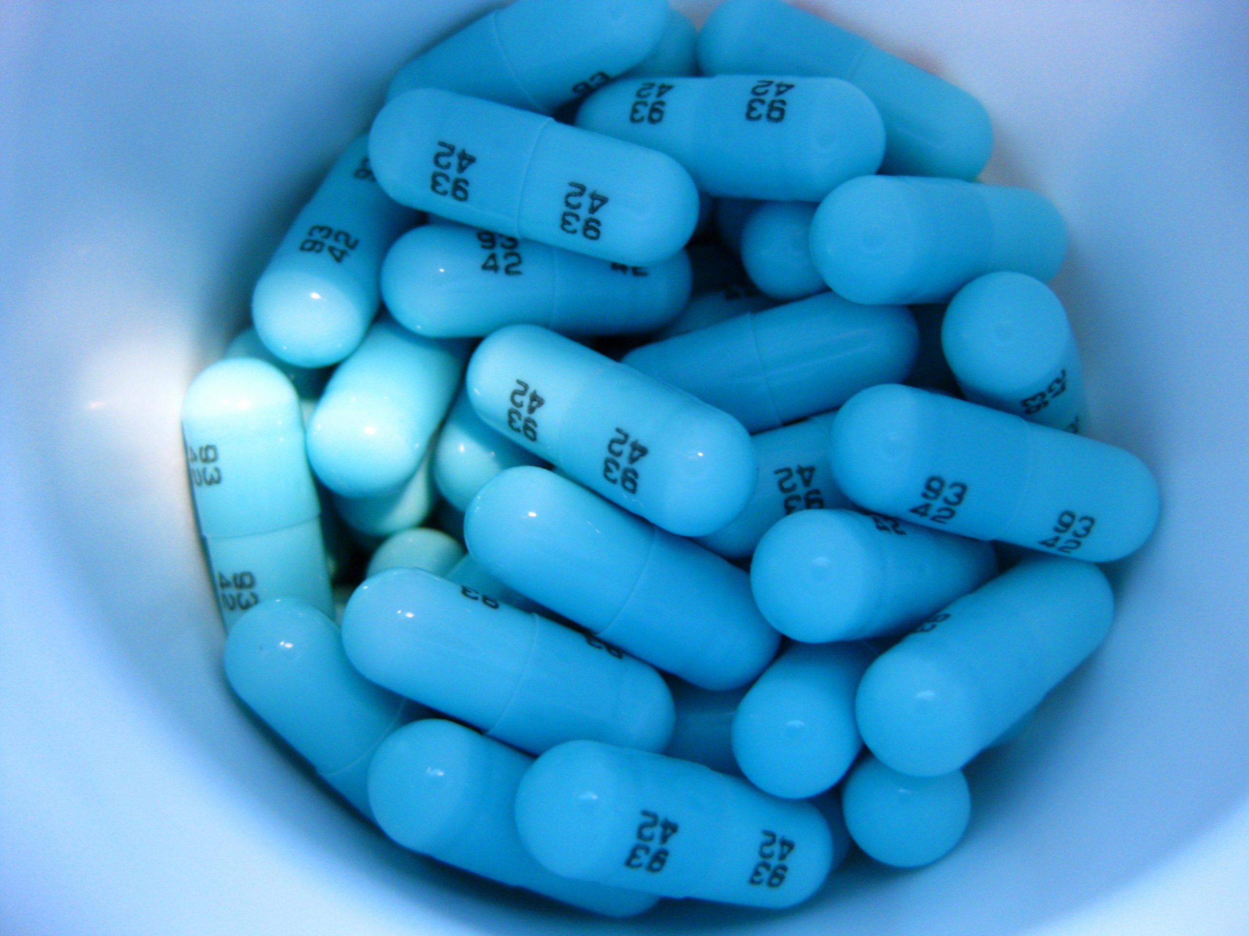 Blue pills in white cup