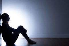Teenager Sitting Alone in Dark Room