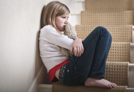 Girl sitting alone on steps.