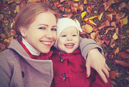 Happy mum and daughter outside in autumn.
