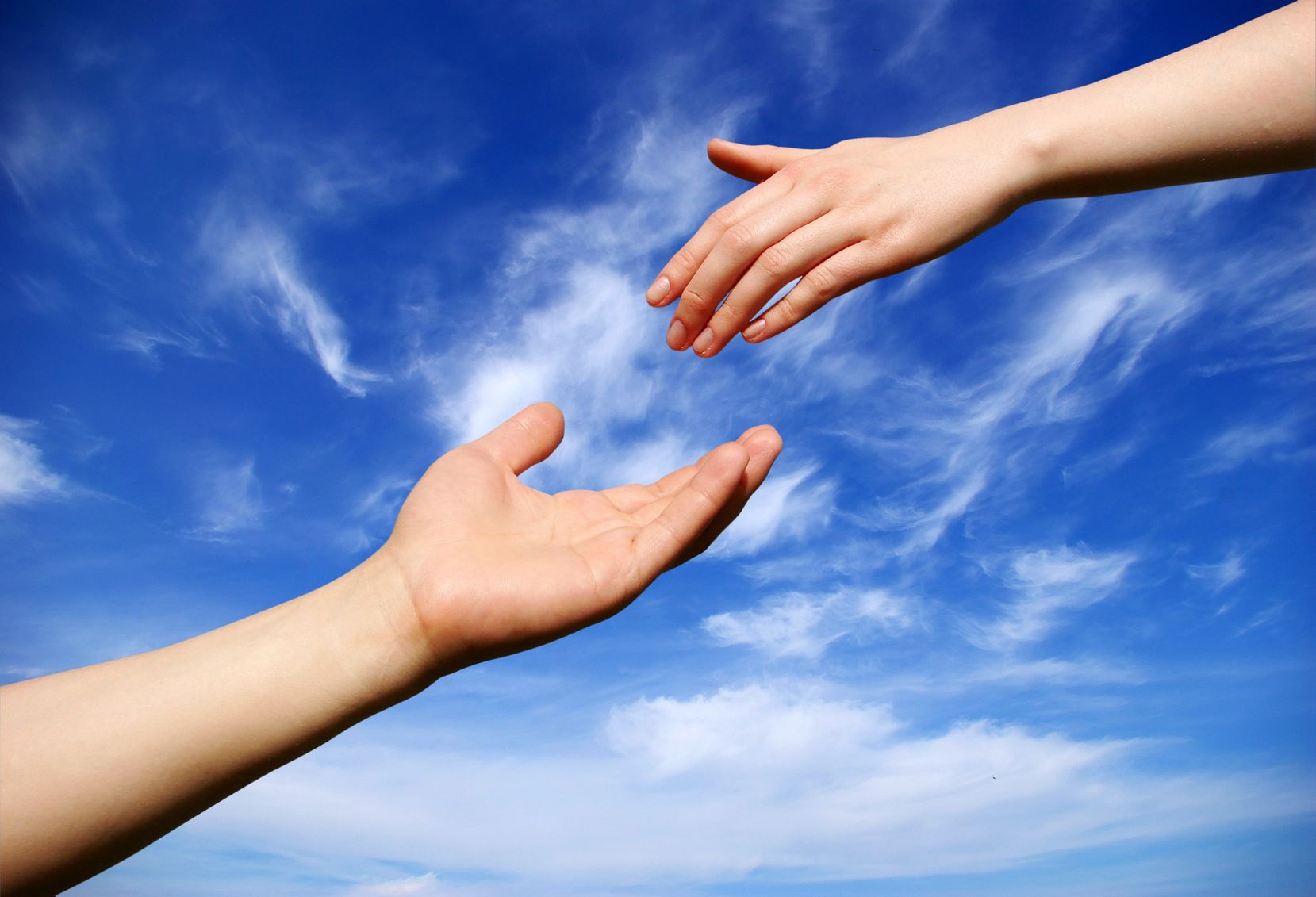 A hand reaching out to another hand.