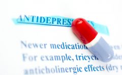 Colored pill on sheet of medicinal side effects-depression.