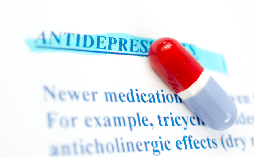 Colored pill on sheet of medicinal side effects-depression.