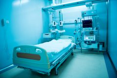 A blue psychiatric hospital bed.